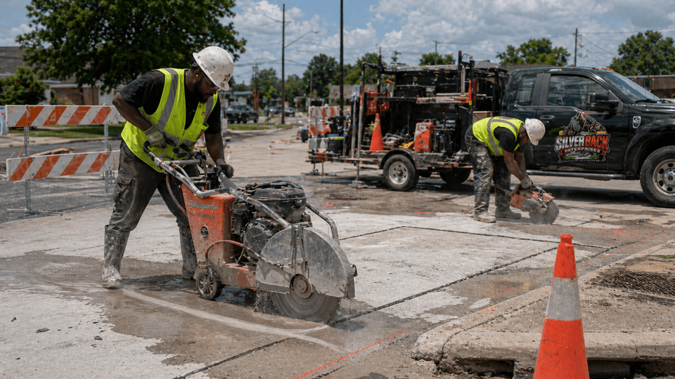 Silverback crew operating walk-behind and handheld concrete saws on a slab
